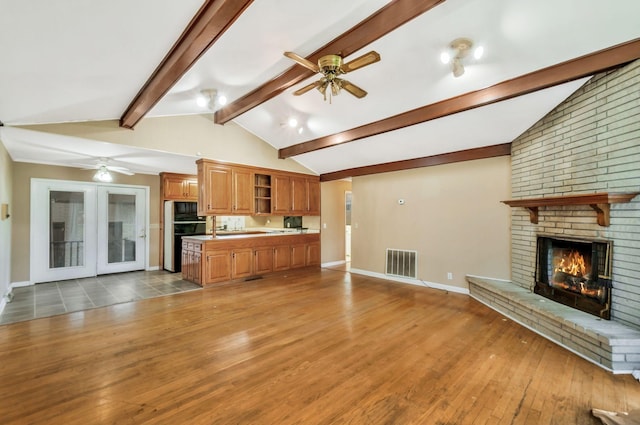 1033 Pine Valley Rd, Kingston Springs, TN 37082 - unfurnished living room with ceiling fan, a brick fireplace, wood finished floors, and baseboards
