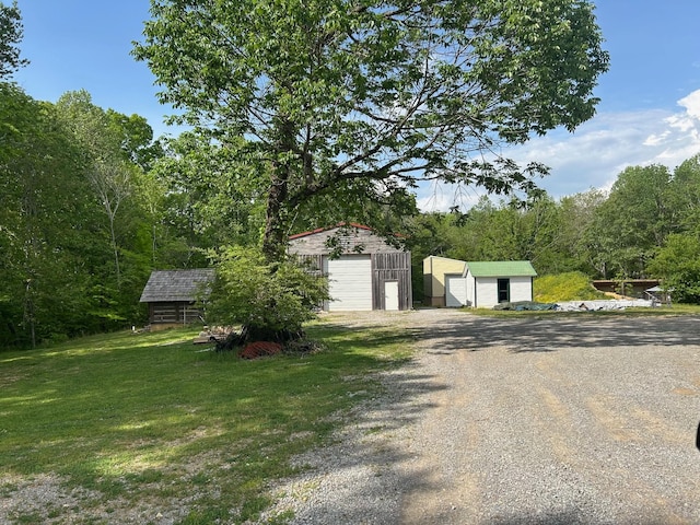 1374 Peter Pond Rd, Ashland City, TN 37015 - view of front of property with a garage, an outbuilding, a front lawn, and gravel driveway