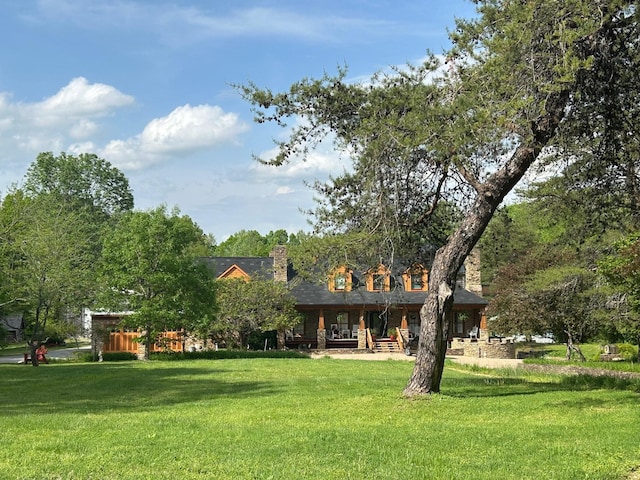 1374 Peter Pond Rd, Ashland City, TN 37015 - rear view of house featuring a yard, a chimney, and covered porch