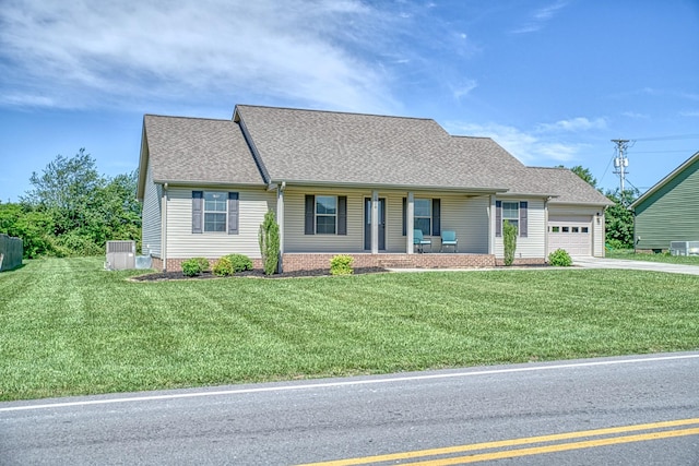 1570 Clemmons Rd, Cookeville, TN 38501 - view of front facade with a porch, an attached garage, roof with shingles, concrete driveway, and a front yard