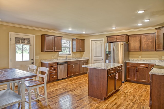 1570 Clemmons Rd, Cookeville, TN 38501 - kitchen featuring stainless steel appliances, healthy amount of natural light, a kitchen island, ornamental molding, and light wood finished floors