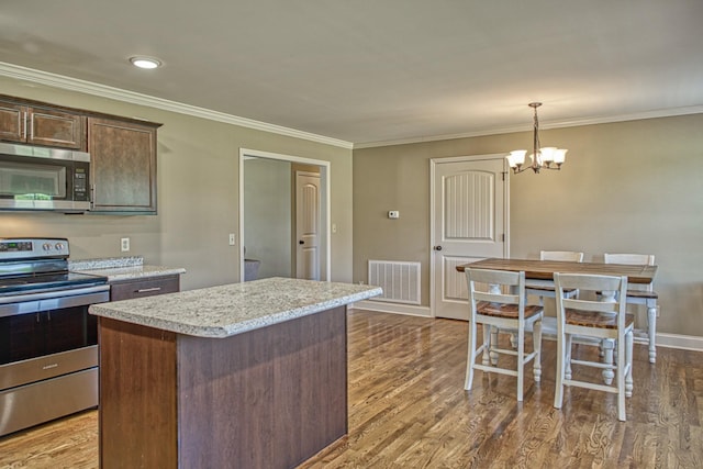 1570 Clemmons Rd, Cookeville, TN 38501 - kitchen featuring stainless steel appliances, a center island, a chandelier, dark wood-type flooring, and ornamental molding