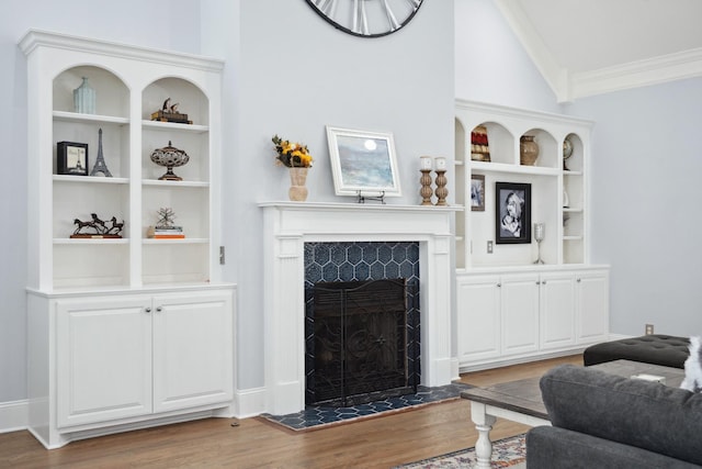 9702 Amethyst Ln, Brentwood, TN 37027 - living room with wood finished floors, crown molding, a tile fireplace, lofted ceiling, and built in shelves