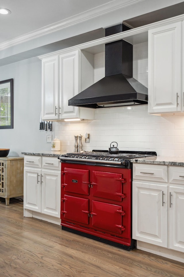 9702 Amethyst Ln, Brentwood, TN 37027 - kitchen with wall chimney range hood, crown molding, light wood-type flooring, white cabinets, and tasteful backsplash