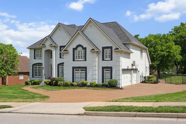 9702 Amethyst Ln, Brentwood, TN 37027 - french country style house featuring driveway, a garage, and brick siding