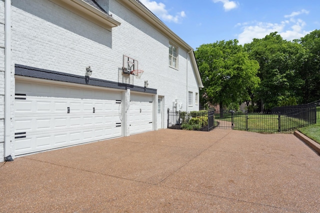 9702 Amethyst Ln, Brentwood, TN 37027 - view of side of home with concrete driveway, brick siding, fence, and an attached garage