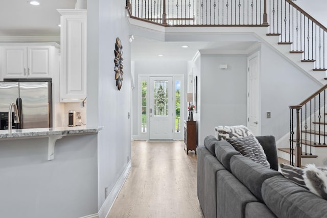 9702 Amethyst Ln, Brentwood, TN 37027 - living room with stairs, light wood-style floors, recessed lighting, baseboards, and a high ceiling