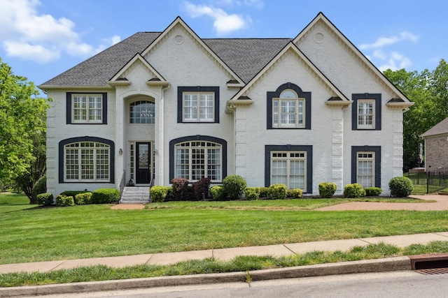 9702 Amethyst Ln, Brentwood, TN 37027 - view of front facade with a front yard, brick siding, and roof with shingles