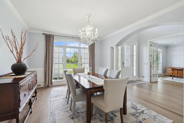 9702 Amethyst Ln, Brentwood, TN 37027 - dining space with arched walkways, a chandelier, healthy amount of natural light, ornamental molding, and light wood-type flooring