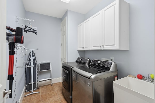 9702 Amethyst Ln, Brentwood, TN 37027 - laundry area featuring cabinet space, washing machine and dryer, baseboards, and light tile patterned flooring