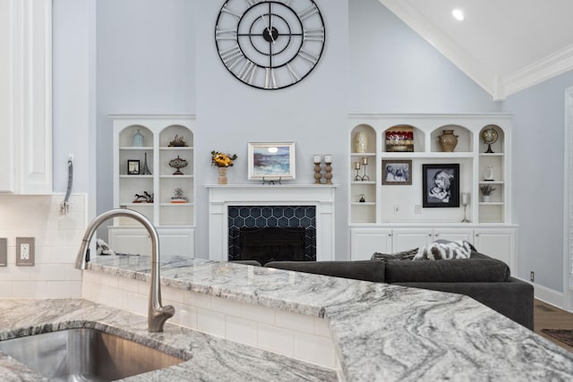 9702 Amethyst Ln, Brentwood, TN 37027 - living room with high vaulted ceiling, wood finished floors, a high end fireplace, ornamental molding, and built in shelves