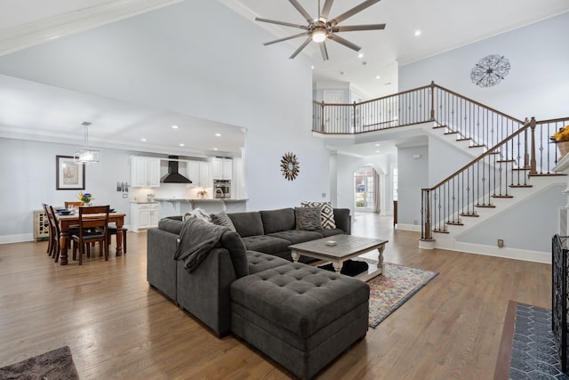 9702 Amethyst Ln, Brentwood, TN 37027 - living area with ceiling fan, arched walkways, stairway, wood finished floors, and a high ceiling