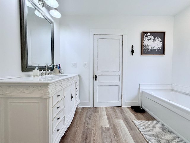 540 Grindstone Hollow Rd, Dickson, TN 37055 - bathroom with wood finished floors, vanity, a garden tub, and baseboards