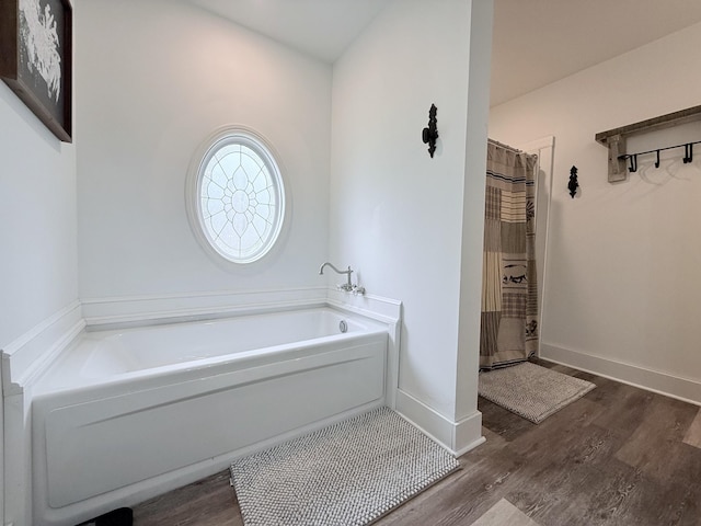 540 Grindstone Hollow Rd, Dickson, TN 37055 - full bath featuring wood finished floors, a bath, a shower with shower curtain, and baseboards