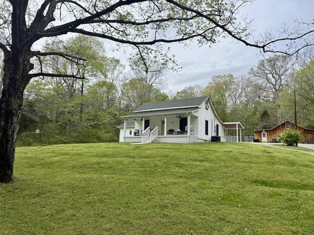 540 Grindstone Hollow Rd, Dickson, TN 37055 - rear view of property with a porch, a yard, an outbuilding, and central AC unit