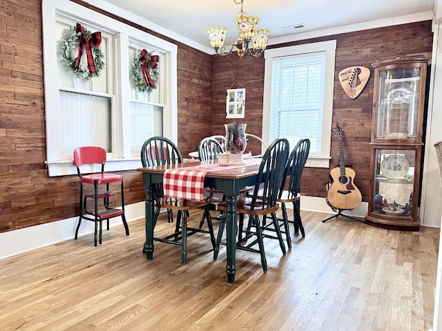 540 Grindstone Hollow Rd, Dickson, TN 37055 - dining area with a chandelier, light wood finished floors, and wooden walls
