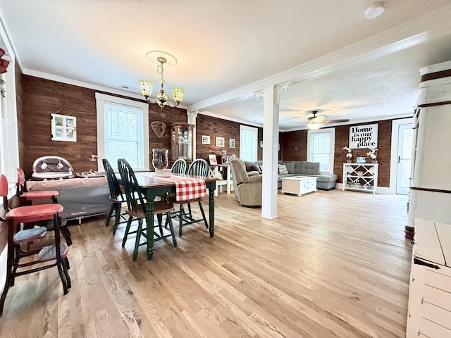 540 Grindstone Hollow Rd, Dickson, TN 37055 - dining area featuring wooden walls, light wood finished floors, ornamental molding, ceiling fan, and a chandelier