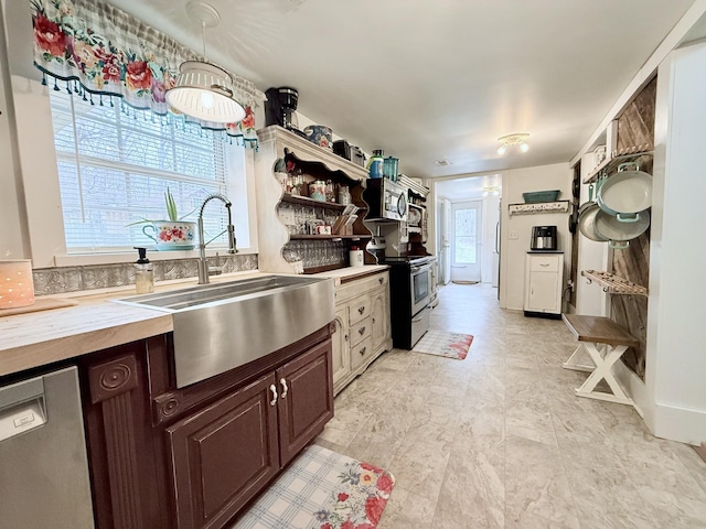 540 Grindstone Hollow Rd, Dickson, TN 37055 - kitchen with appliances with stainless steel finishes, a sink, dark brown cabinetry, butcher block countertops, and open shelves