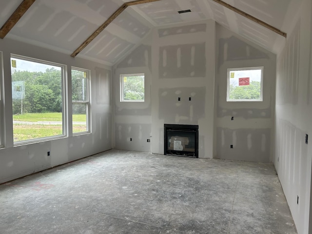 7321 Winners Rd, Murfreesboro, TN 37129 - unfurnished living room with a glass covered fireplace, vaulted ceiling, and plenty of natural light