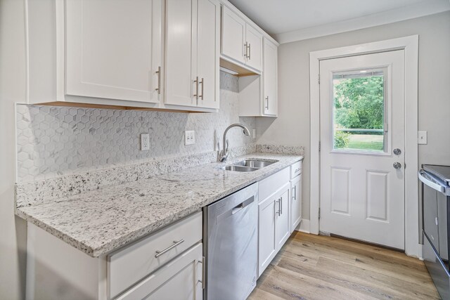 1301 Neelys Bend Rd Unit 50, Madison, TN 37115 - kitchen featuring appliances with stainless steel finishes, a sink, white cabinetry, light stone counters, and light wood-style floors