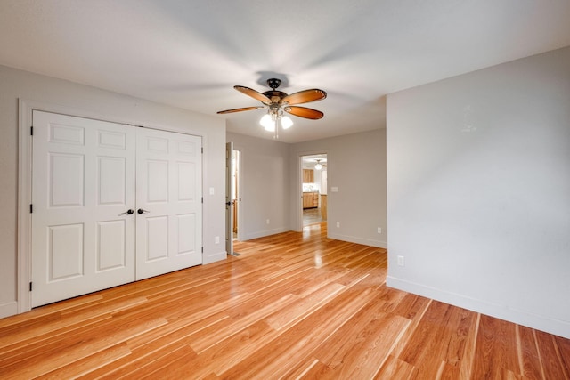 102 Hobbs Ridge Rd, Dunlap, TN 37327 - unfurnished bedroom with light wood-style flooring, baseboards, a closet, and a ceiling fan