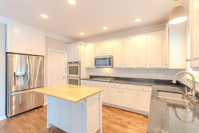 2004 Towhee Ct, Spring Hill, TN 37174 - kitchen with appliances with stainless steel finishes, a sink, white cabinetry, crown molding, and wood counters