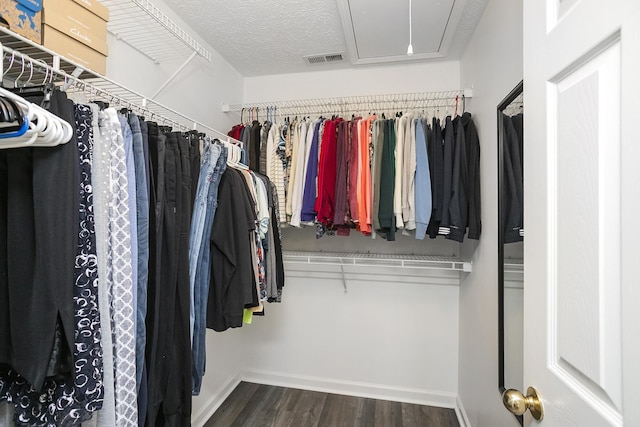 spacious closet featuring attic access and wood finished floors