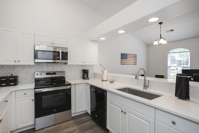 kitchen with stainless steel appliances, a sink, lofted ceiling, white cabinetry, and recessed lighting