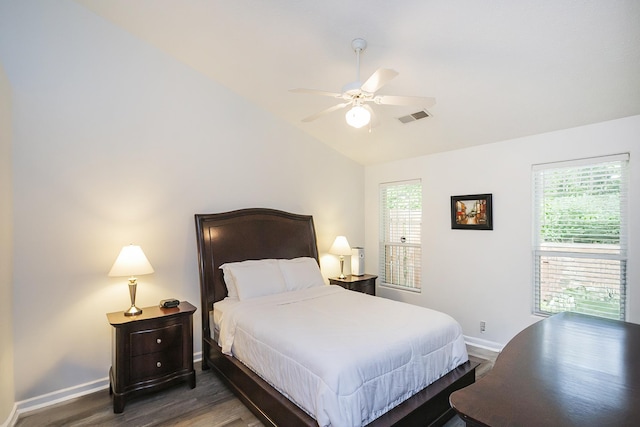 bedroom with lofted ceiling, baseboards, wood finished floors, and a ceiling fan