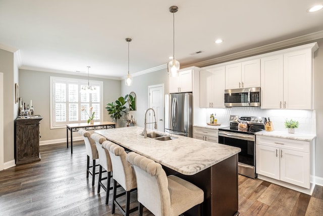 1551 Dobbins Pike, Gallatin, TN 37066 - kitchen with appliances with stainless steel finishes, a sink, ornamental molding, decorative backsplash, and a center island with sink