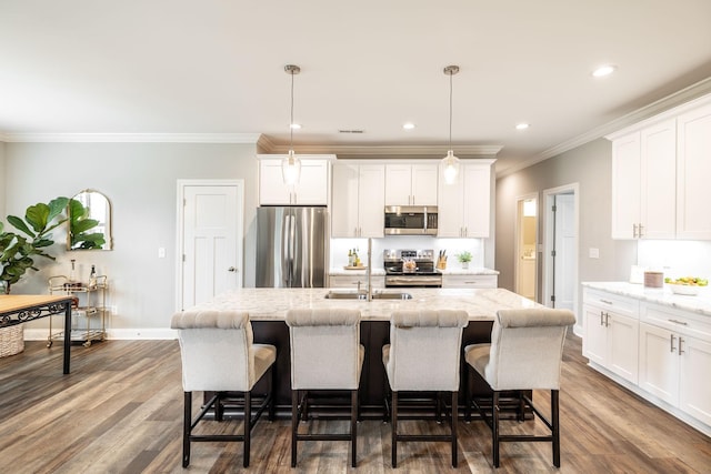 1551 Dobbins Pike, Gallatin, TN 37066 - kitchen featuring stainless steel appliances, a sink, a center island with sink, crown molding, and dark wood finished floors