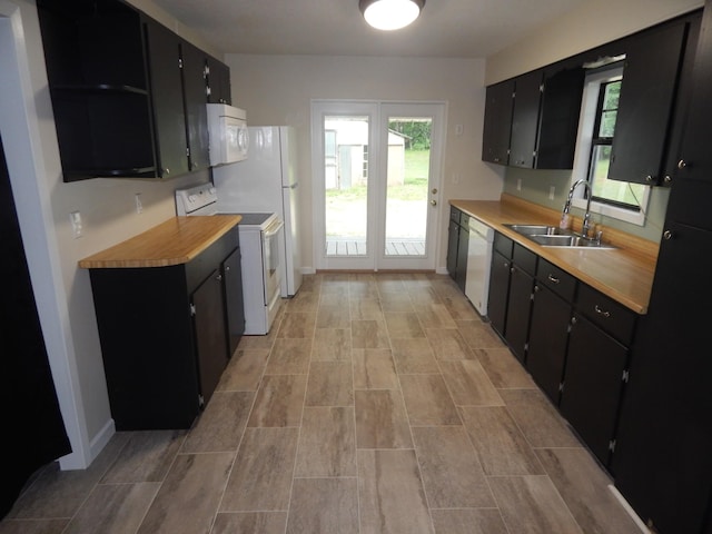 3355 Willie Mauldon Rd, Lutts, TN 38471 - kitchen featuring white appliances, dark cabinets, a sink, light countertops, and baseboards