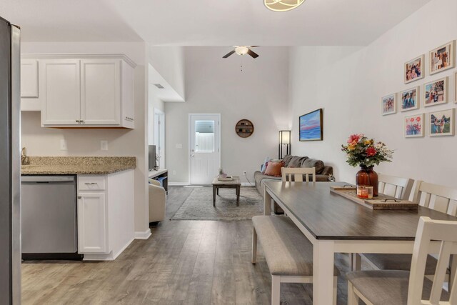3507 Learning Ln, Murfreesboro, TN 37128 - dining area featuring a ceiling fan, light wood-type flooring, baseboards, and a high ceiling