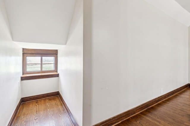bonus room featuring wood finished floors and baseboards