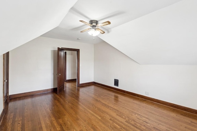 bonus room featuring vaulted ceiling, a ceiling fan, wood finished floors, and baseboards