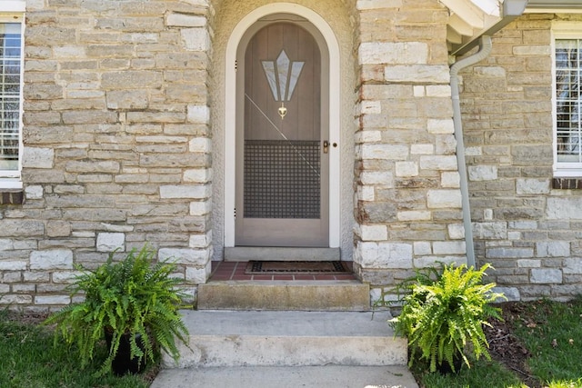 doorway to property featuring stone siding