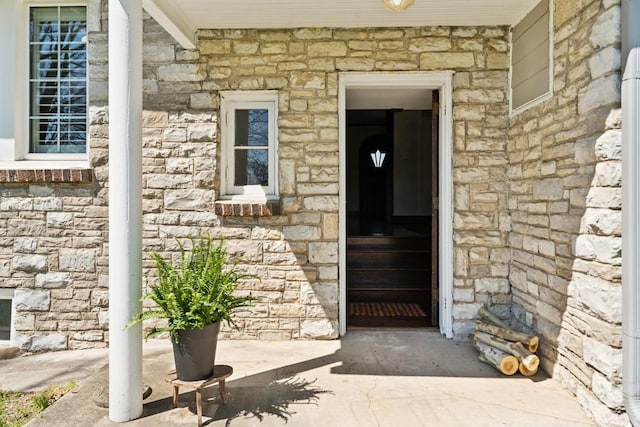 doorway to property featuring stone siding