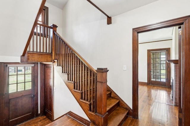 stairs featuring wood-type flooring and baseboards