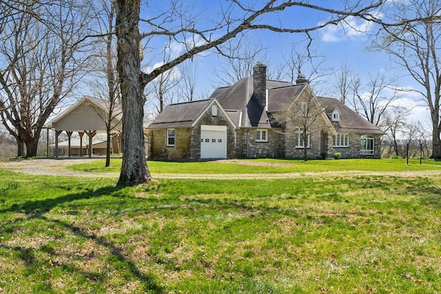 view of front of house with a chimney, a front lawn, and a garage