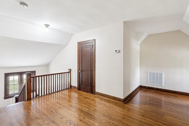 bonus room with lofted ceiling, wood finished floors, and baseboards