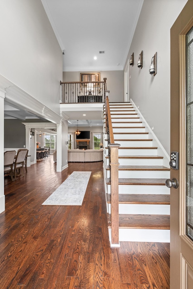 4999 Crescent Ln, Murfreesboro, TN 37128 - stairs with ornate columns, a towering ceiling, crown molding, wood finished floors, and baseboards