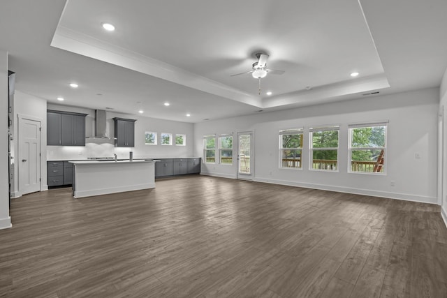 310 Carver Ln, Lebanon, TN 37087 - unfurnished living room featuring a raised ceiling, a ceiling fan, recessed lighting, dark wood-style flooring, and baseboards