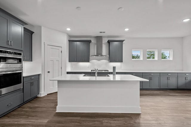 310 Carver Ln, Lebanon, TN 37087 - kitchen with wall chimney range hood, stainless steel double oven, light countertops, gray cabinetry, and recessed lighting