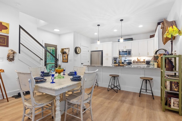 726 Morgan Ave, Woodbury, TN 37190 - dining area with light wood-style flooring, recessed lighting, and stairway