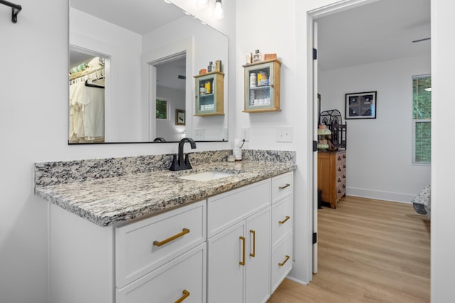 726 Morgan Ave, Woodbury, TN 37190 - bathroom with vanity, wood finished floors, and baseboards