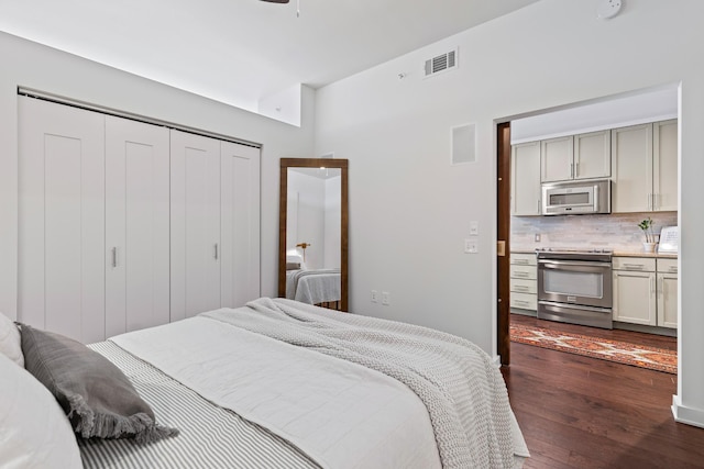 bedroom featuring dark wood finished floors and a closet