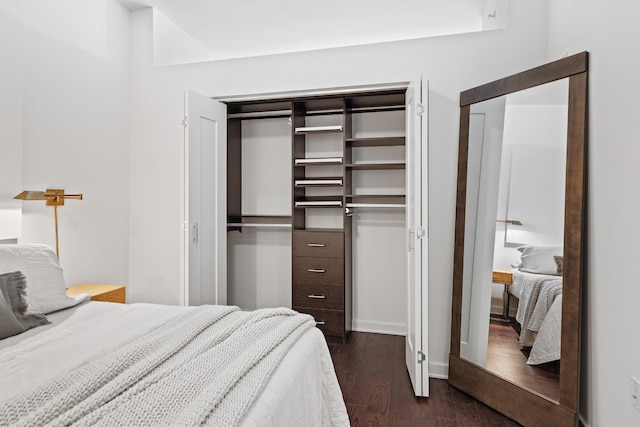 bedroom featuring dark wood-style floors and multiple closets
