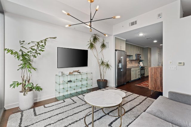 living room featuring a chandelier, dark wood-type flooring, baseboards, and recessed lighting