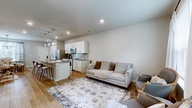 1768 Frodo Way, Murfreesboro, TN 37128 - living room with a chandelier, recessed lighting, light wood-type flooring, and baseboards