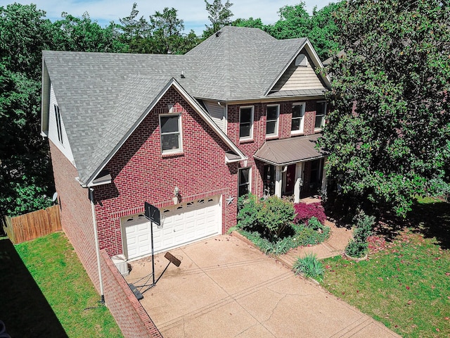 traditional-style home with brick siding, a garage, concrete driveway, and a shingled roof